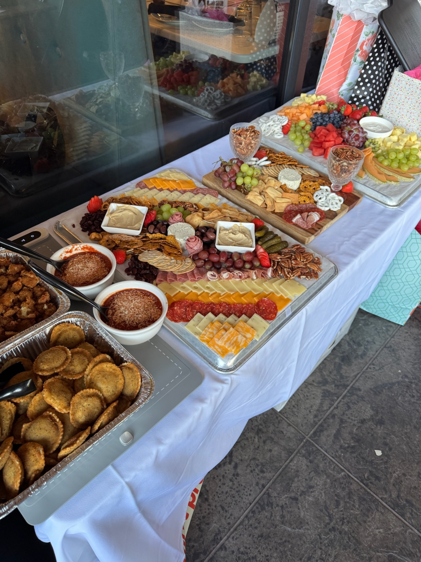 Full-service buffet line with hot trays, charcuterie and fruit