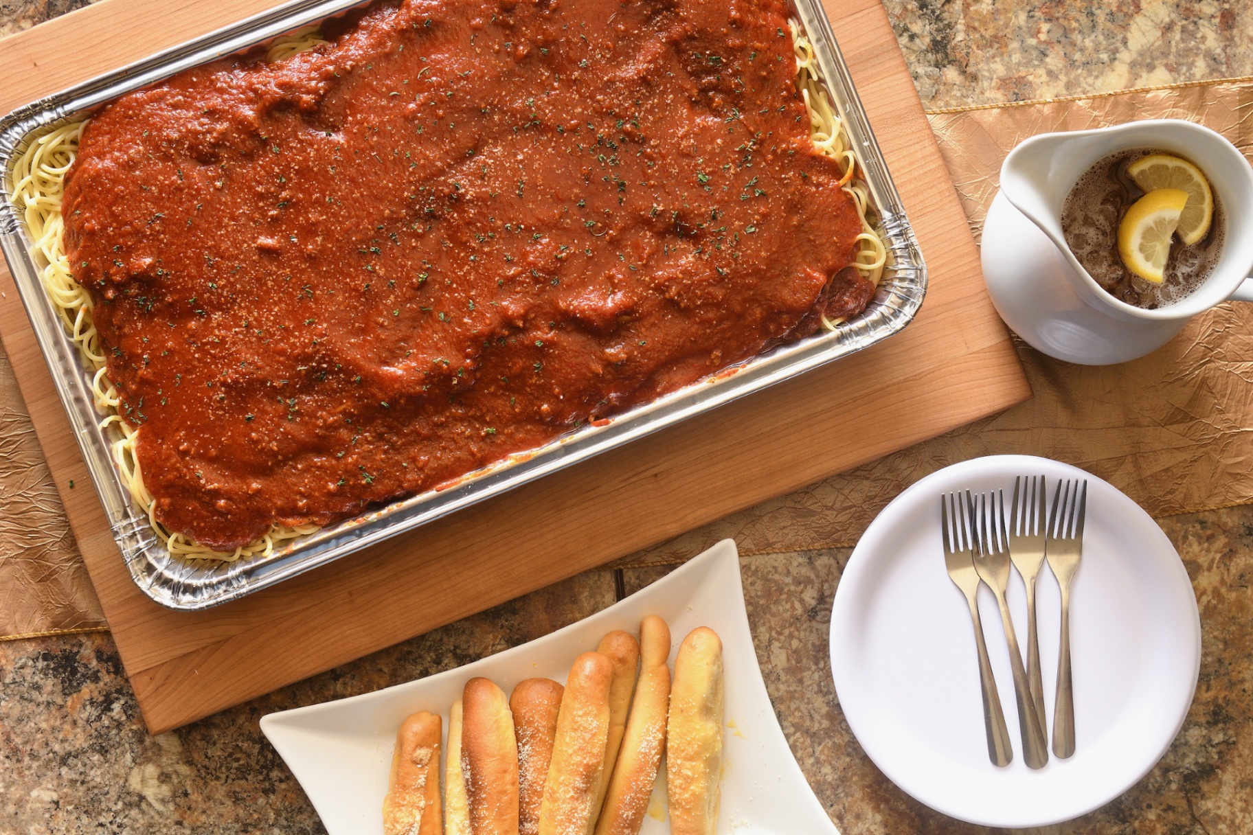 Spaghetti pan plated on a wood board